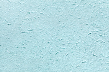 Decorative light soft blue color paper, imitates the old plaster or vintage azure surface of the facade.