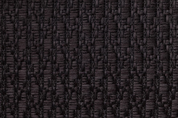 Black knitted woolen background with a pattern of soft, fleecy cloth. Texture of textile closeup.