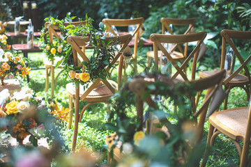 Chair decorated with flowers in forest Wedding ceremony.