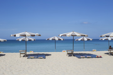 Fototapeta na wymiar Umbrellas in a beautiful day on Surin beach in Phuket Thailand