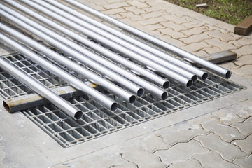 Metal pipes in a warehouse, . Stack of new and shiny steel pipe in factory