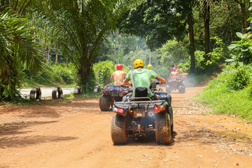 PHUKET, THAILAND - AUGUST 23 : Tourists riding ATV to nature adventure on dirt track on AUGUST 23,...
