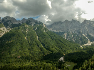 Fototapeta premium Aerial view of beautiful Triglav mountains, part of Alps in Slovenia. Beautiful clouds on top of mountains.