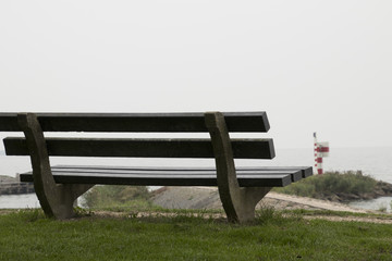 A rustic bench is looking out over the IJsselmeer