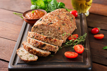Tasty homemade ground  baked turkey meatloaf on wooden table. Food american meat loaf.