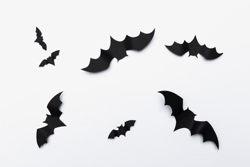 halloween and decoration concept - paper bats flying