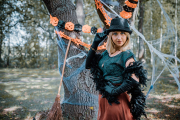 Elegant, charming, shy, playful, flirty, dangerous, mysterious, scary female beauty. Close up portrait of gorgeous happy witch fairy enchantress, covering her eyes, carnaval halloween concept 