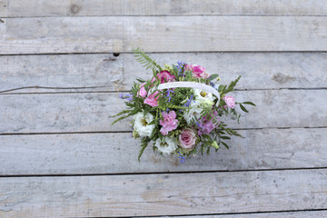 Delicate bouquet of flowers in a white basket