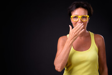 Mature beautiful woman with short hair against black background