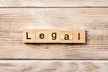 legal word written on wood block. legal text on table, concept