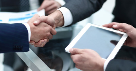 close up.businessman looking at tablet screen