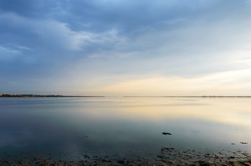 Nice view of the estuary. Sunset over the sea. Calm sea surface. Landscape.