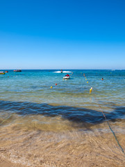  A view of a beach with a water scooters  in Malia. Crete, Greece