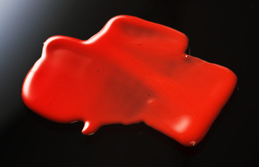 Texture of Red Lipgloss Liquid, Black Background