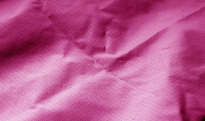 Сrumpled textile surface in pink color.