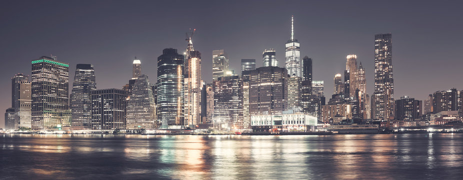 Manhattan skyline at night, color toning applied, USA.