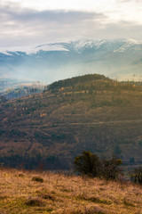 gloomy november scenery in mountains. foggy and hazy forenoon on an overcast day. distant mountain...