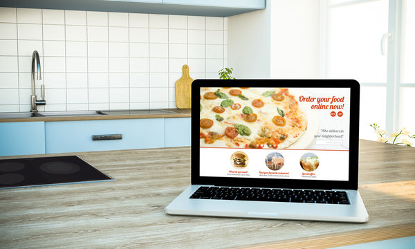 mockup of order food online website screen laptop on cooking island at kitchen