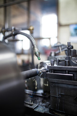 Metallurgy heavy industry. Factory for production industrial machines. Low light close up shot. Short depth of field.