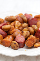 portuguese smoked sausages with chestnuts on white dish