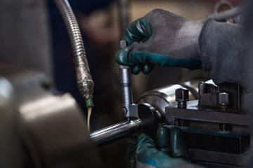Metallurgy heavy industry. Factory for production industrial machines. Low light close up shot. Short depth of field.