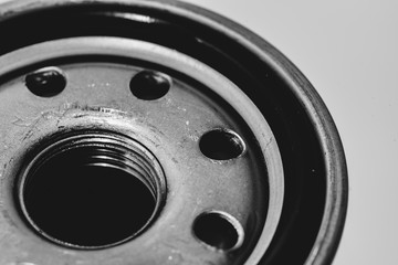 Monochrome background image of oil filter close up. Artwork from auto part in macro photography in grayscale.