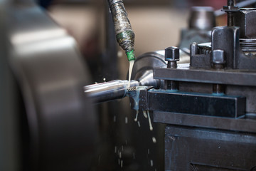 Metallurgy heavy industry. Factory for production industrial machines. Low light close up shot. Short depth of field.