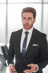close up.confident businessman standing in office