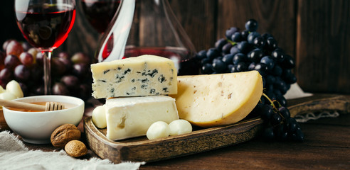 Cheese and wine, Decanter and glasses, wooden background, appetizer, grapes, long banner