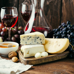 Cheese and wine, Decanter and glasses, wooden background, appetizer, grapes