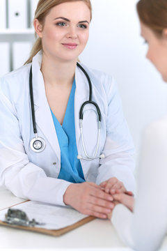 Medicine doctor reassuring her female patient. Medicine, comforting  and trusting concept in health care