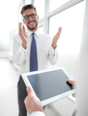 close up.businessman with digital tablet on office background