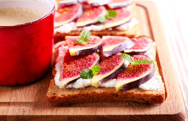 Fig and ricotta open sandwich and cup of coffee