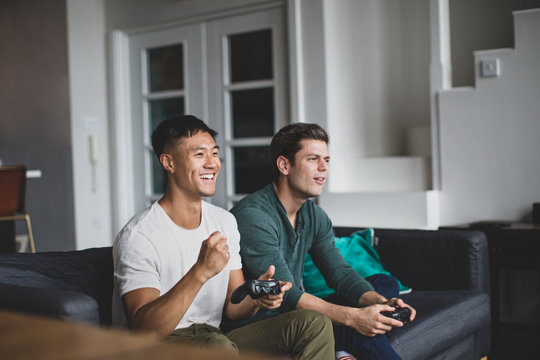 Male friends playing on a games console
