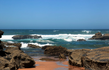 Portugal Ursa Beach at atlantic coast of Atlantic Ocean with rocks and foam at sand of coastline picturesque landscape panorama. Stones with green moss. © as_trofey