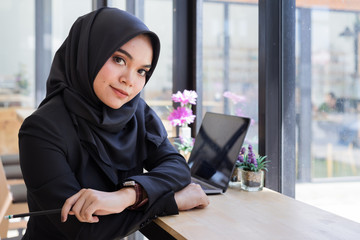 portrait of young muslim business people wearing black hijab,working in coworking.