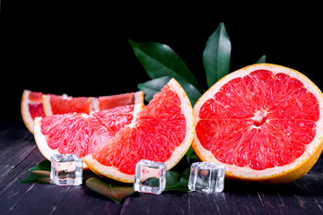 orange and grapefruit juice On a wooden black background