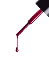 still life of nail polish brush with a falling drop