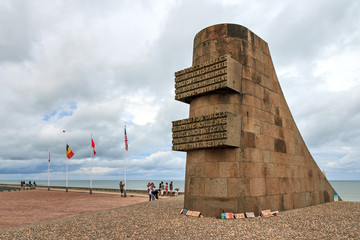 Tourists visit the D-day monument on Omaha beach in Normandy, France, on August 2, 2014
 - obrazy, fototapety, plakaty