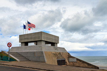 Beautiful view of the WW2 Omaha Beach National Guard Monument in Normandy, France, build on the remains of a german bunker - obrazy, fototapety, plakaty