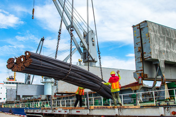 bundle of steel rod being loading discharging in port terminal, handle by gang of stevedore,...
