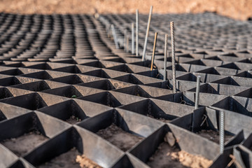 black geogrid filled with a soil for stability of steep hill