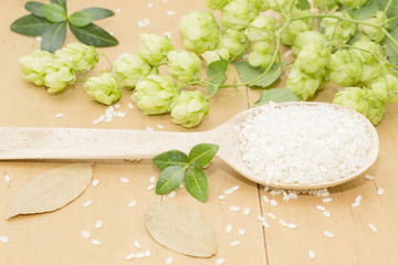a branch of hops, rice and a wooden spoon