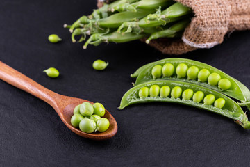 Sugar snap peas with mint on a rustic wood background