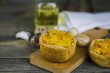 Baked puff pastry with potato filling and cheese on a wooden board