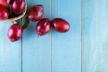 Sweet plums on wooden background