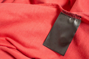 blank black color clothing label on red t shirt