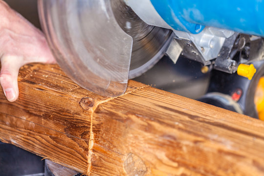 Close up from a buzz saw cuts a wood