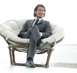confident businessman sitting in a large comfortable chair.