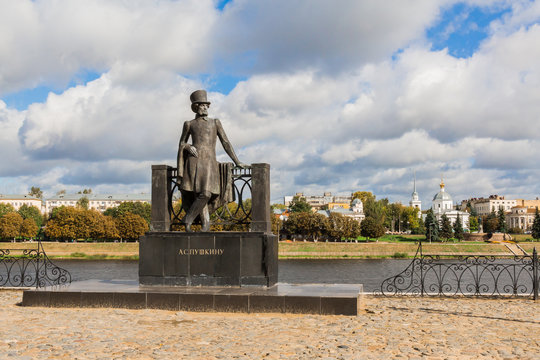 Monument to Russian poet Alexander Pushkin on the embankment in Tver, Russia. Volga river embankment. Autumn day. Picturesque landscape. Church of the Resurrection on the opposite Bank.